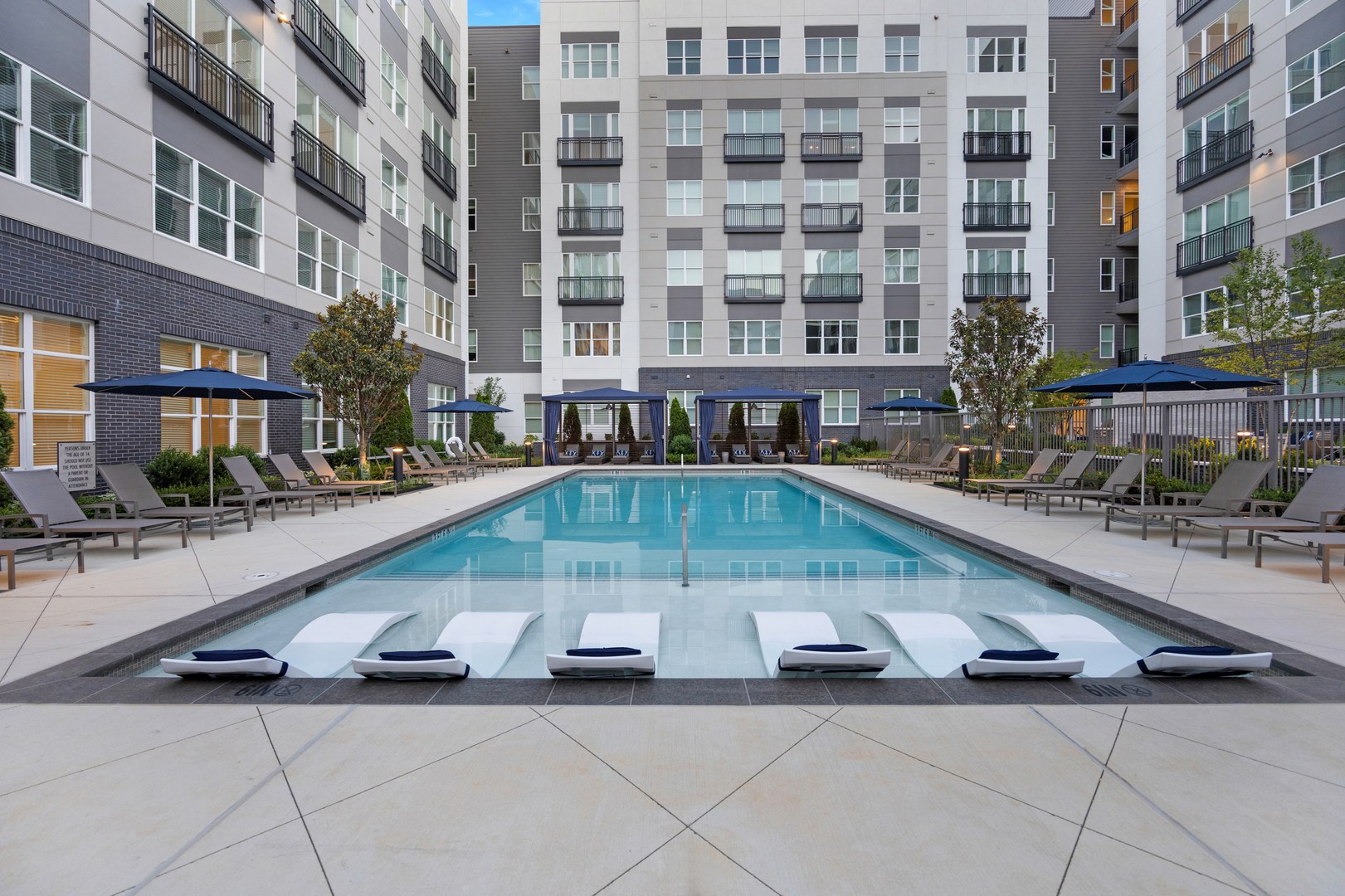 Enjoy a perfect poolside day with inviting cabanas and refreshing waters.